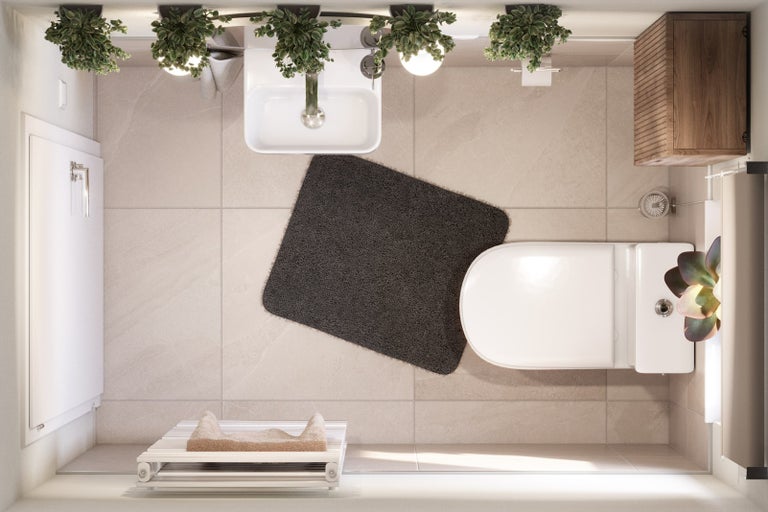 Pohľad zhora na kúpeľňu s umývadlom, toaletou, kúpeľňovou predložkou a radiátorom