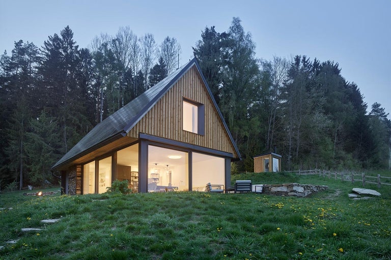 Moderný drevený dom s veľkými oknami vo vidieckom prostredí