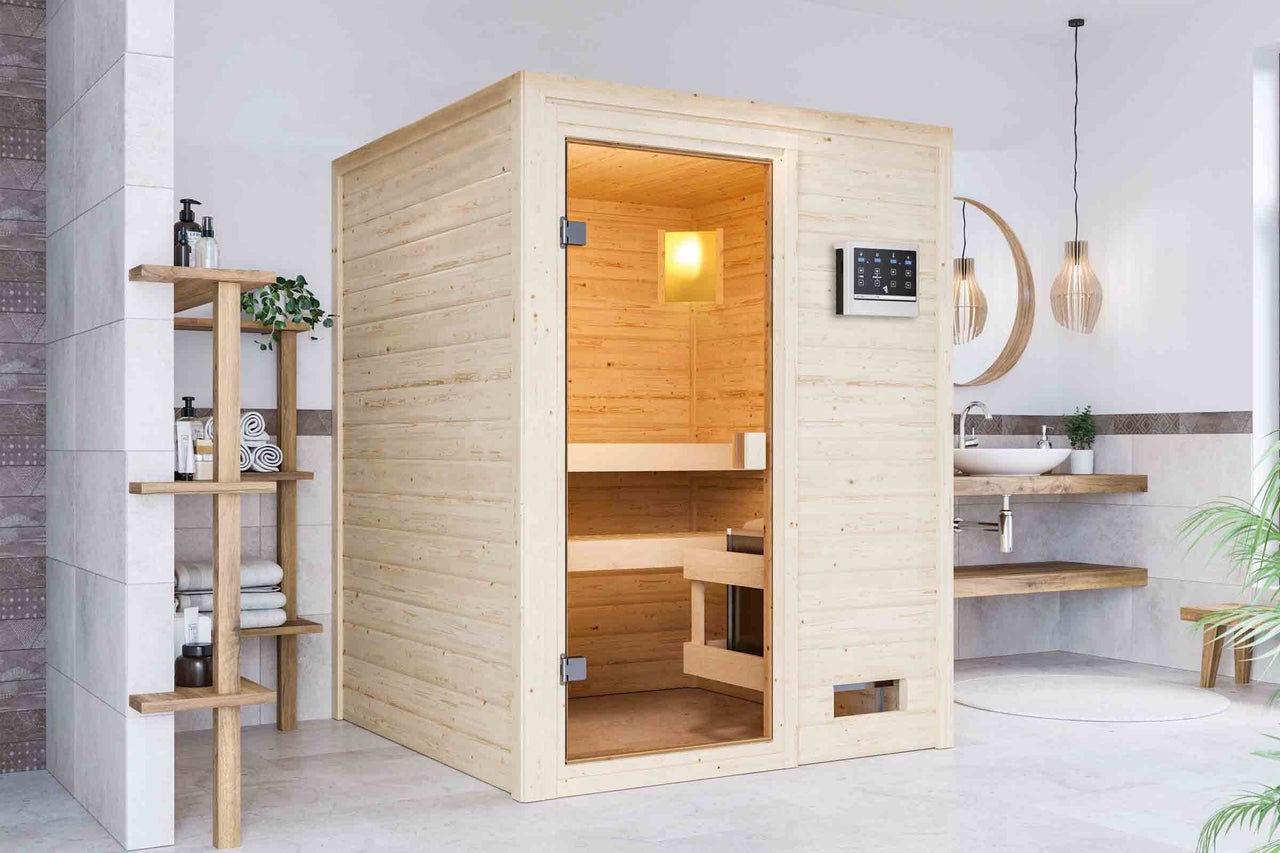 Moderná sauna z dreva so sklenenými dverami v kúpeľni.