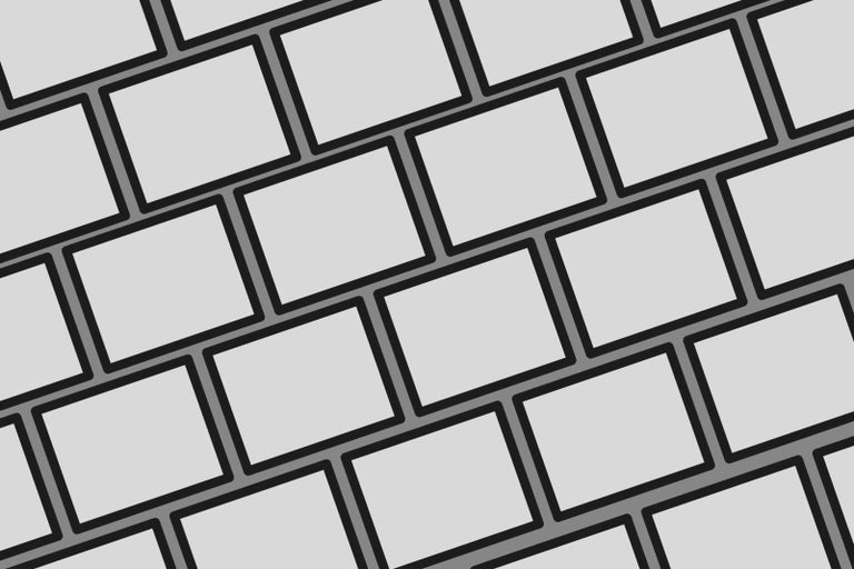 Mnoho sivých obdĺžnikových kameňov leží šikmo vedľa seba.