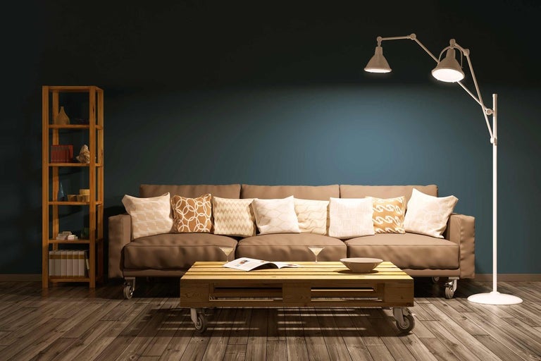 Obývacia izba s pohovkou, konferenčným stolíkom z paliet, stojacou lampou a regálom