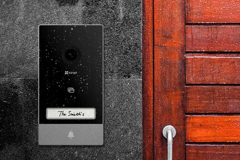 EZVIZ video zvonček na stene vedľa drevených dverí
