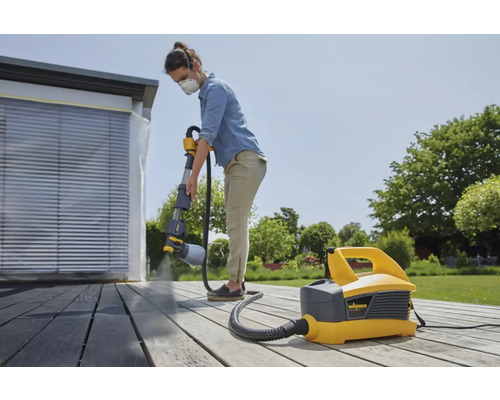 "Žena natiera terasu pomocou systému na striekanie farieb