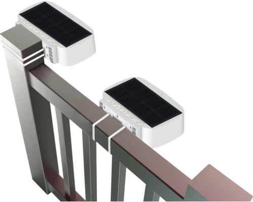 Dve solárne svietidlá pripevnené k plotu