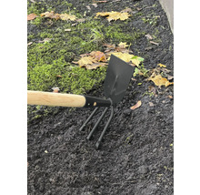 Záhradné náradie s drevenou násadou a trojzubými hrotmi v záhone