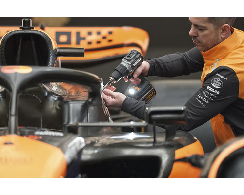 Mechanik používa akumulátorový skrutkovač na pretekárskom aute.