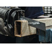 Chvostová píla reže kovovú rúrku v zveráku.