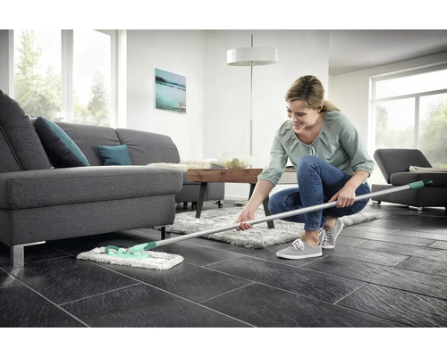 Žena vytiera podlahu v obývacej izbe mopom