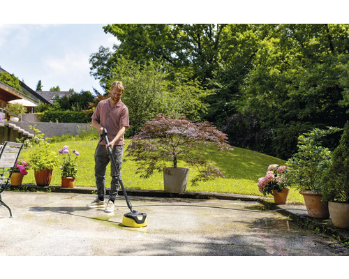 Muž čistí terasu čističom terás