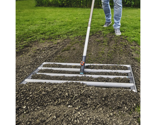 Úprava pôdy pomocou urovnávacej lišty v záhrade.