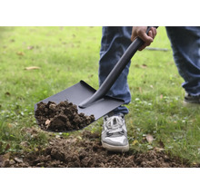 Osoba lopatou naberá hlinu.