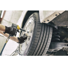 Mechanik mení koleso pomocou rázového uťahováka.