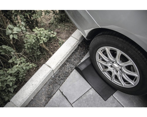 Nájazdový klin pod pneumatikou auta na dlažobných kockách