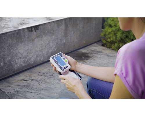 Osoba drží v ruke merač vlhkosti pôdy Gardena