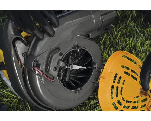 Rozložený drvič na trávniku s viditeľnou čepeľou rotora