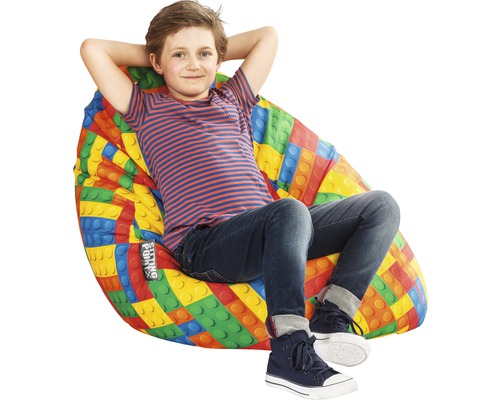 Chlapec sedí v sedacom vaku s dizajnom stavebných blokov.