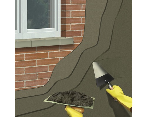 Vonkajšia izolácia stien so špachtľou a lyžicou na stene domu