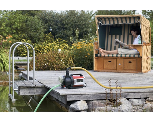 Záhradná krajina s jazierkom, čerpadlom a plážovým košom na drevenom móle