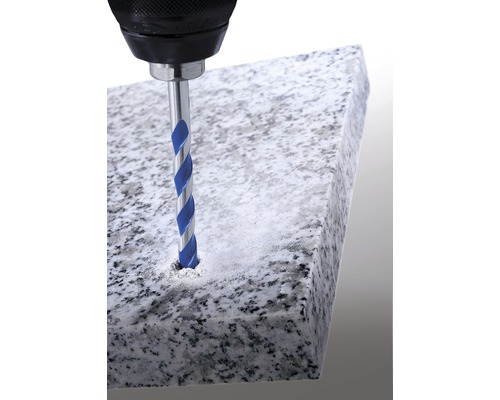 Vŕtačka vŕta kamenným vrtákom otvor do kamennej dosky.