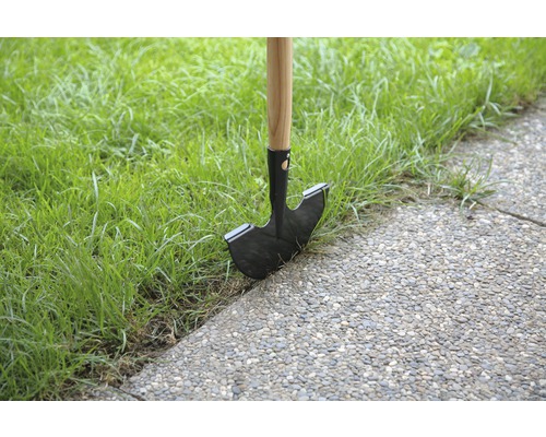 Obrubník trávnika s drevenou rukoväťou a oceľovou čepeľou v trávniku