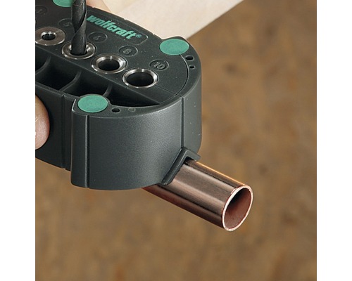 Wolfcraft logo. Vŕtacia šablóna pre rúrky pri vŕtaní.