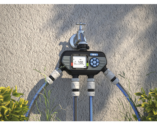 Automatické ovládanie zavlažovania s dvoma výstupmi namontované na vodovodný kohútik.