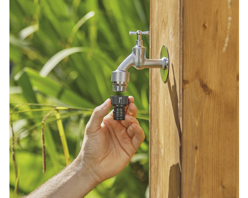 Ruka pripája konektor kohútika k záhradnému kohútiku.