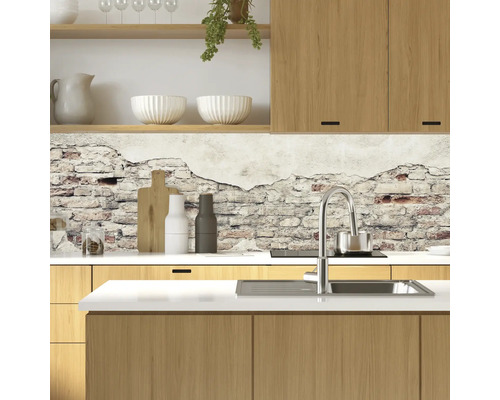 Kuchynská scéna s drevenými skrinkami, drezom, batériou a stenou so vzorom tehál.