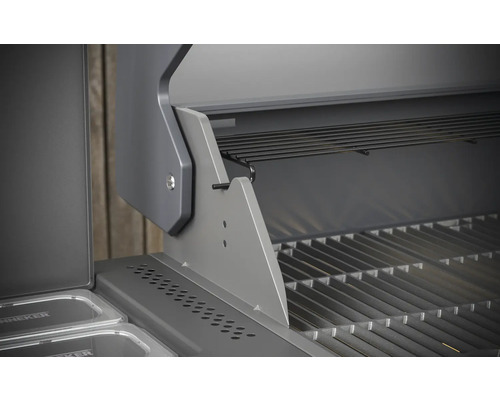 Detailný pohľad na otvorený plynový gril s grilovacím roštom a ohrievacím roštom