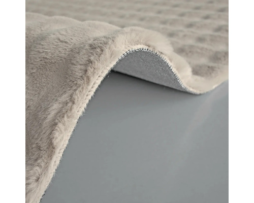 Detail sivého koberca s chlpatým povrchom