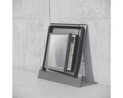 Okno zabudované do sivej betónovej steny s čiastočne otvoreným okenným krídlom.