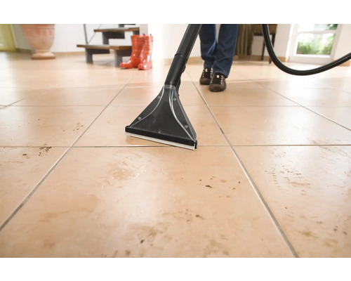 Čistenie podlahy pomocou čistiaceho vysávača na dlaždicovej podlahe