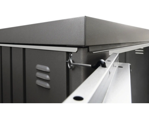 Detailný pohľad na kovovú skriňu na náradie s vetracími otvormi a západkou dverí