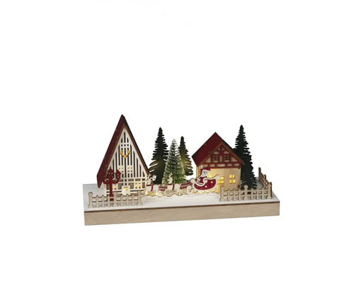 Dekoratívna vianočná scéna s domami, stromami a Santa Clausom na saniach.