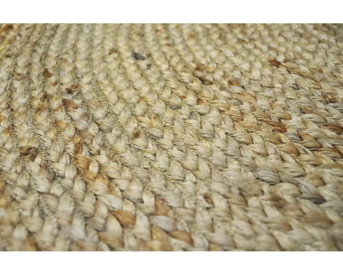 Detailný pohľad na pletený koberec z prírodných vlákien.