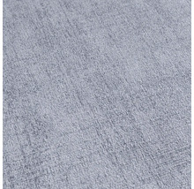 Detail svetlej, štruktúrovanej textílie.