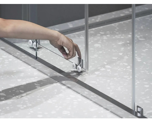 Detailný záber sprchových dverí s rolovacím vedením a rukou.