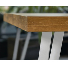 Detailný pohľad na drevenú stolovú dosku s kovovými nohami