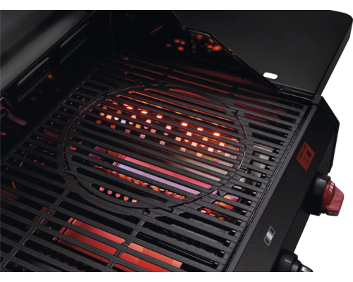 Pohľad do otvoreného grilu s grilovacím roštom a zapnutým kúrením