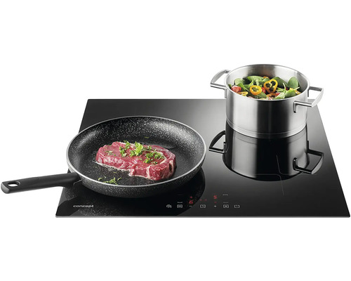 Indukčná varná doska Concept s panvicou so steakom a hrncom so zeleninou.