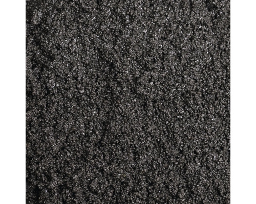 Detailný záber jemnozrnného tmavého posypového materiálu alebo granulátu ako textúry.