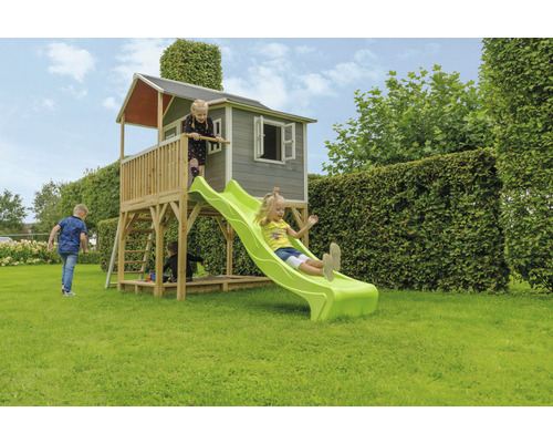 Hracia veža so šmýkačkou a pieskoviskom v záhrade s hrajúcimi sa deťmi