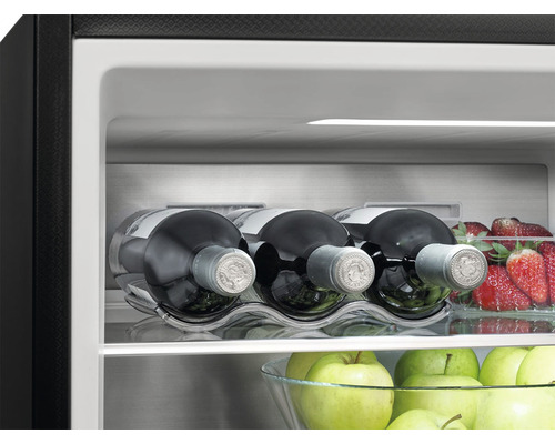 Interiér chladničky s fľašami vína, jahodami a jablkami