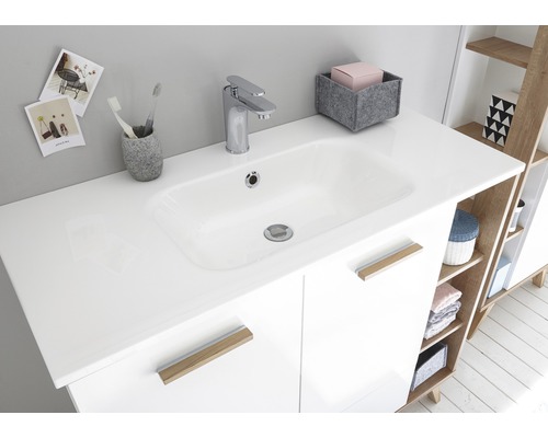 Moderné kúpeľňové umývadlo s batériou a úložným priestorom.