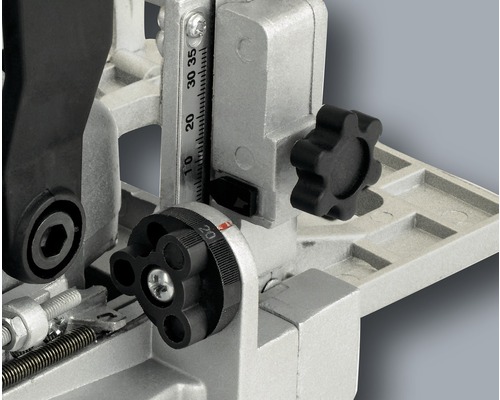 Detailný pohľad na drevoobrábaciu frézku s nastavovacími kolieskami a stupnicou pre presné nastavenie.