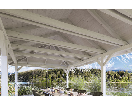 Vnútorný pohľad na záhradný altánok s drevenou strechou a jedálenským stolom