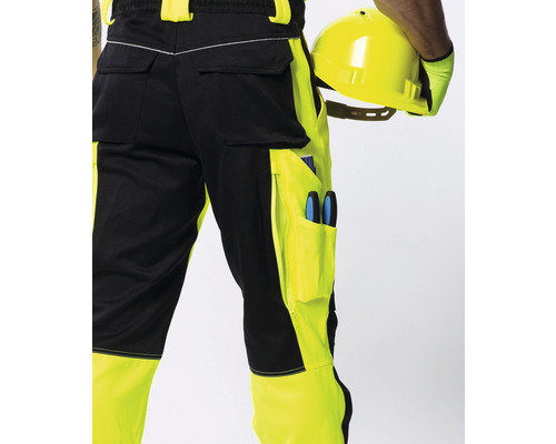 Čierne a žlté pracovné nohavice s náradím a helmou