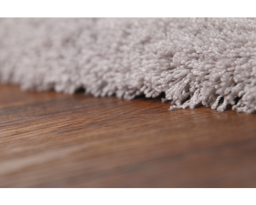 Detailný pohľad na koberec s hnedou drevenou podlahou