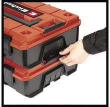 Ruka otvára dva kufríky na náradie značky Einhell.