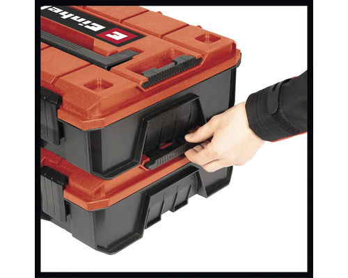 Ruka otvára dva kufríky na náradie značky Einhell.